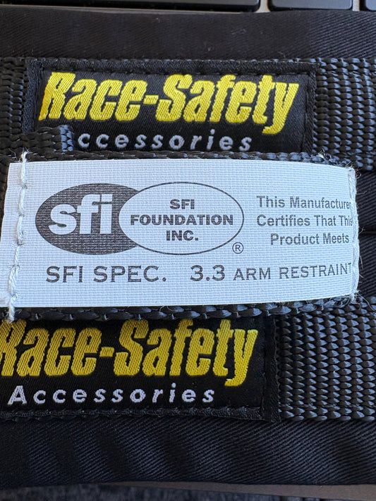 Race-Safety Accessories arm restraint label showing SFI Spec 3.3 identification on black webbing