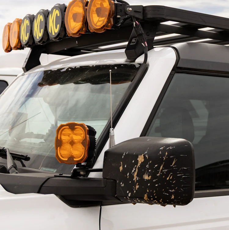 POINT5 UHF CB off-road antenna beside the windscreen and mirror of a white vehicle