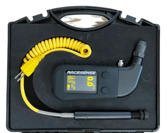 Racesense tire pressure monitor with coiled cable in a black case on a white background