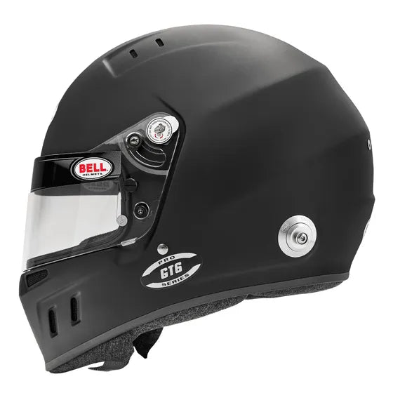 Black racing helmet with clear visor on a white background