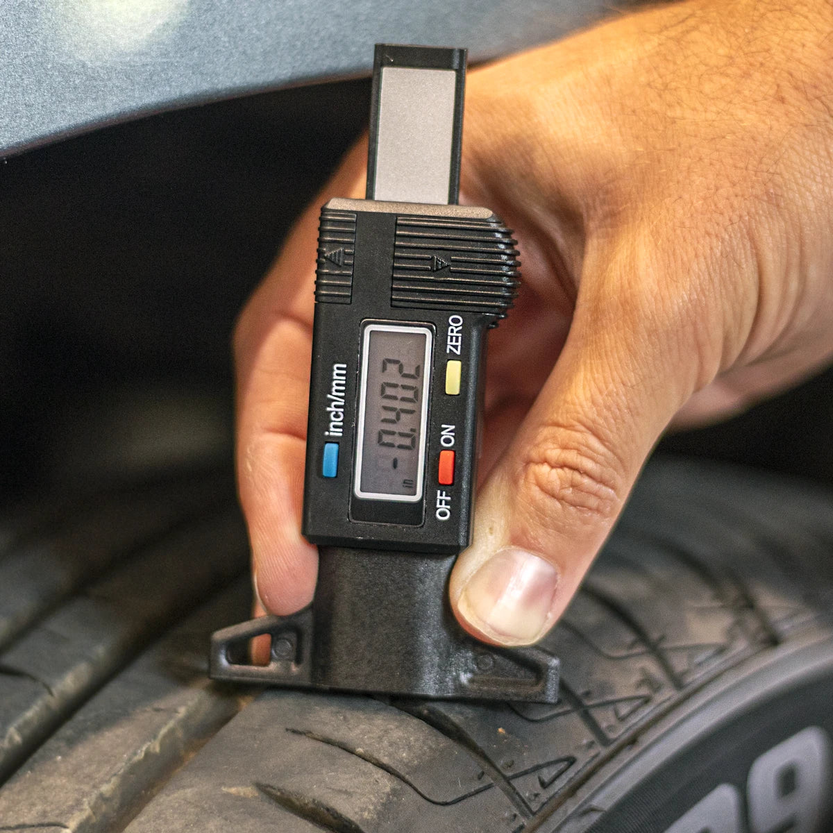 B-G Racing BG5152 digital tyre tread depth gauge being used to measure tread on a race tyre