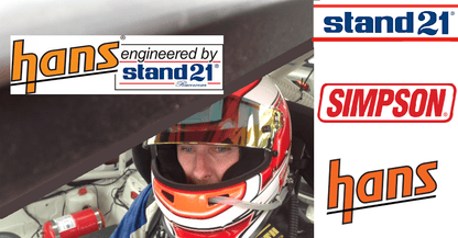 Aaron Harris at the Barcelona 24 Hour race with Stand 21 Club 1 HANS FHR device — FIA approval label and tether clips visible