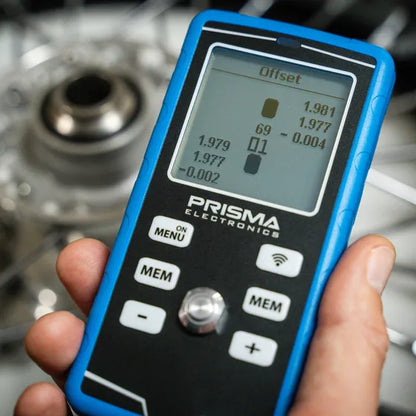 Prisma HPM5 infrared tyre pyrometer and pressure gauge with its custom aluminium chuck on a racing wheel valve